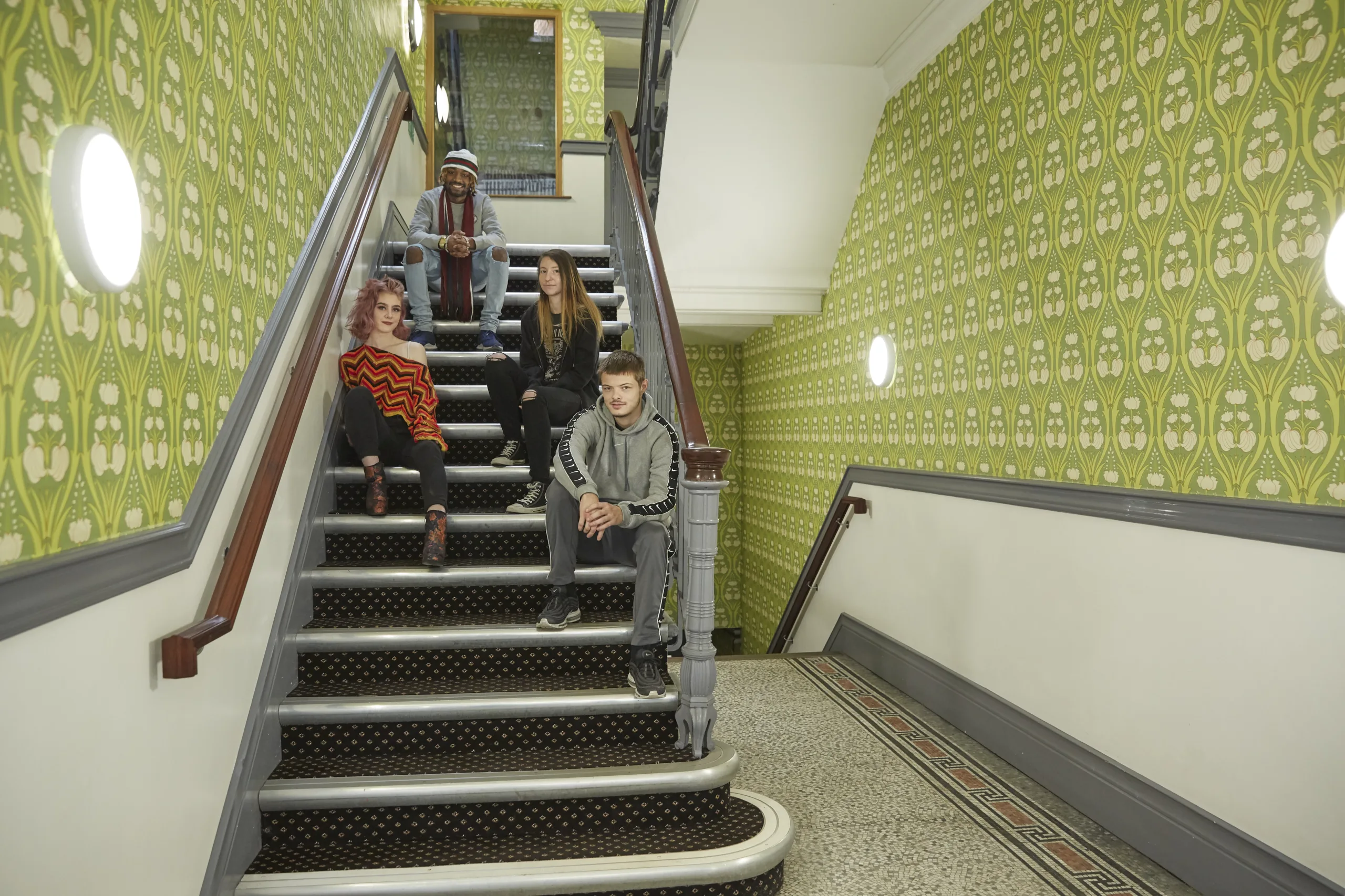 group of young people sitting on a staircase